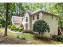 Side view of a distinguished home featuring a well-kept lawn and attractive architectural details at 8255 Habersham Waters Rd, Atlanta, GA 30350
