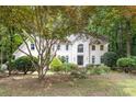 Stately home exterior with a lush front yard and mature trees enhancing curb appeal at 8255 Habersham Waters Rd, Atlanta, GA 30350
