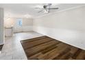 Bright open-concept living area with tiled floors transitioning to modern wood flooring at 145 Washington St, Mcdonough, GA 30253
