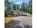 Exterior angle shot showcases a carport and a deck with stair access at 976 Bakers Bridge Rd, Douglasville, GA 30134