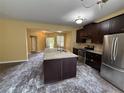 A spacious kitchen featuring stainless steel appliances, an island and plenty of counter space at 102 Daisy Cir, Mcdonough, GA 30252