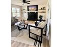 Bright living room featuring contemporary furniture, stylish rug, and a decorative fireplace at 112 Village Ct, Woodstock, GA 30188
