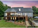A large backyard with a deck and patio offers outdoor entertaining and relaxation spaces at 1280 Trinity Church Rd, Canton, GA 30115