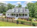 Beautiful exterior showcasing a landscaped front yard and a charming, inviting front porch at 1280 Trinity Church Rd, Canton, GA 30115