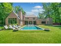Beautiful backyard features a large pool with lounge chairs and lush green landscaping at 3146 Frontenac Ne Ct, Atlanta, GA 30319