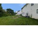 Backyard and side view of vinyl sided house under a sunny sky at 3679 Seabass Rd, Decatur, GA 30034