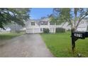 Two-story home with vinyl siding, two-car garage with a mailbox with the number 3679 at 3679 Seabass Rd, Decatur, GA 30034