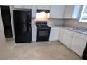 Kitchen featuring white cabinets, black appliances, and light countertops at 3679 Seabass Rd, Decatur, GA 30034