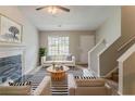 Inviting living room features a fireplace, neutral color palette, and ample natural light at 6114 Leverett Dr, Lithonia, GA 30038