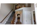 Inviting foyer with staircase and wood flooring leading to other rooms at 6385 Southland Forest Dr, Stone Mountain, GA 30087