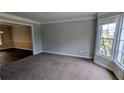 Bright living room features neutral carpeting and a large bay window at 6385 Southland Forest Dr, Stone Mountain, GA 30087