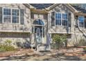 View of front entrance featuring leaded glass sidelights, stone accents and covered porch at 13 Cliff Ct, Villa Rica, GA 30180