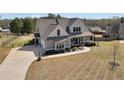 Beautiful two-story home with a long driveway and a meticulously maintained lawn at 220 Alcovy Reserve Way, Covington, GA 30014