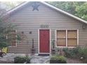 Quaint home with a red door and decorative star, exuding rustic charm and curb appeal at 2363 Paul Nw Ave, Atlanta, GA 30318