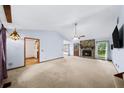 Spacious living room featuring a stone fireplace, high ceilings, and ample natural light at 1880 Doefield St, Canton, GA 30115