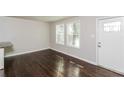 Inviting living room with gleaming hardwood floors, a bright front door and large windows at 2500 Swallow Circle Southeast Se Cir, Atlanta, GA 30315