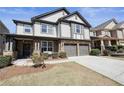 Beautiful two-story home featuring a covered porch, stone accents, and attached two car garage at 5470 Beaver Ridge Dr, Cumming, GA 30040