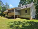Exterior of a home with a screened-in porch and a lush green backyard, perfect for outdoor enjoyment at 105 Old Hickory Pointe, Mcdonough, GA 30252