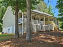 Charming view of the exterior side of the home showcasing a delightful elevated porch at 105 Old Hickory Pointe, Mcdonough, GA 30252