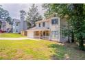 Inviting two-story home with a stone-accented porch, attached garage, and well-maintained lawn at 5292 Mountain Village Ct, Stone Mountain, GA 30083