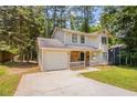 Well-kept two-story home with stone facade details, a cozy porch, and attached single car garage at 5292 Mountain Village Ct, Stone Mountain, GA 30083