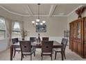 Elegant dining room boasts coffered ceilings, wainscoting, and a dark wood dining set at 6370 Stillwood Ln, Cumming, GA 30041