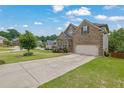 Beautiful two-story home features a two-car garage and a long driveway at 6370 Stillwood Ln, Cumming, GA 30041
