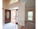 Bright foyer with marble tile floor, a decorative front door, and traditional wall trim details at 830 Cramac Dr, Lawrenceville, GA 30046