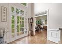 Bright foyer with hardwood floors, double doors, and high ceilings at 120 Forest Breeze Cv, Alpharetta, GA 30022
