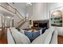Open-concept living room with vaulted ceilings, a stone fireplace, and hardwood floors at 1055 Beacon Hill Xing, Alpharetta, GA 30005