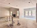 Spacious living room features a fireplace and views from multiple windows, with drywall ready for paint at 133 West Lake Blvd, Carrollton, GA 30116
