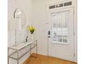 Stylish entryway with a marble console table, mirror, and hardwood floors at 2457 Birkhall Way # 2457, Lawrenceville, GA 30043