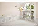 Formal dining room featuring wainscoting, a large window, and a chandelier at 3753 Honey Pot Ne Way, Marietta, GA 30066