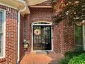 Inviting brick entryway featuring double doors with a wreath and decorative flower pot at 3753 Honey Pot Ne Way, Marietta, GA 30066