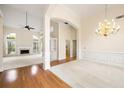 Open-concept living room with fireplace, hardwood floors, and a decorative chandelier at 3753 Honey Pot Ne Way, Marietta, GA 30066