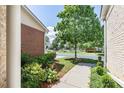 Green front yard with manicured shrubs and a view of the neighborhood street at 3916 Abbott Way # 2, Powder Springs, GA 30127