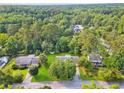 A residential neighborhood surrounded by mature trees and lush greenery at 3690 Basswood Rd, Snellville, GA 30039