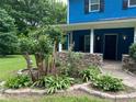 Attractive porch featuring well-manicured landscaping and a stone accent at 5560 Old Bill Cook Rd, College Park, GA 30349