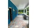 Spacious porch with stone tile flooring, and a stone accent wall at 5560 Old Bill Cook Rd, College Park, GA 30349