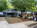 View of the charming bungalow home with a stylish brick front porch in a residential neighborhood at 944 Woodland Ave, Atlanta, GA 30316