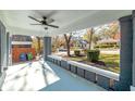 Covered front porch featuring brick columns, ceiling fan, and seating area at 944 Woodland Ave, Atlanta, GA 30316