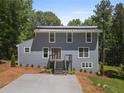Charming two-story home with a modern metal roof and a freshly poured concrete driveway at 2158 Huckleberry Ln, Lithia Springs, GA 30122