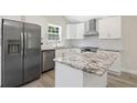 Bright kitchen featuring stainless steel appliances, granite countertops, and white cabinetry at 2158 Huckleberry Ln, Lithia Springs, GA 30122