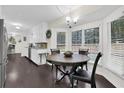 Eat-in kitchen featuring granite countertops, stainless steel appliances, and wood flooring at 4180 Gables Pl, Buford, GA 30519