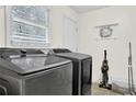 Functional laundry room featuring modern washer and dryer, storage, and natural light at 4180 Gables Pl, Buford, GA 30519