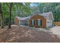 Well-maintained brick home featuring an attached garage, a cozy porch, and a paved walkway at 4180 Gables Pl, Buford, GA 30519
