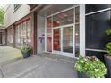 Modern building entrance with glass doors, planters, and a well-maintained exterior creating a professional impression at 878 Peachtree Ne St # 704, Atlanta, GA 30309