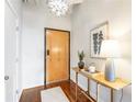 Inviting entryway with hardwood floors, stylish lighting, and a charming accent table with decorative elements at 878 Peachtree Ne St # 704, Atlanta, GA 30309