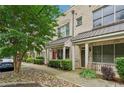 Exterior view of townhouses with covered porches, sidewalk, landscaping, and well-kept bushes at 190 Marion Ne Pl, Atlanta, GA 30307