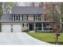Charming two-story home boasts a welcoming front porch and well-maintained landscaping at 2263 Hill Creek Way, Marietta, GA 30062